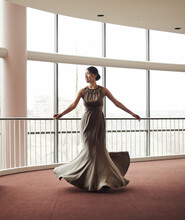 Woman, Elegant Dress And Dancing In Hallway, Fashion And Classy Garment In Lobby For Event. Female Person, Twirl And Satin Garment Movement Or Luxury And Designer Outfit, Aesthetic And Satin Style