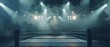 An empty boxing ring set in an arena with dramatic overhead lights creating a moody and atmospheric ambiance.