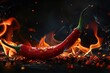 Red hot chili pepper burns on black background,A flaming hot red chilli pepper on fire. Burning hot spicy chilli food
