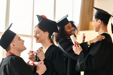 Wall Mural - A multicultural group of students in graduation gowns and caps celebrating their academic achievements with smiles.