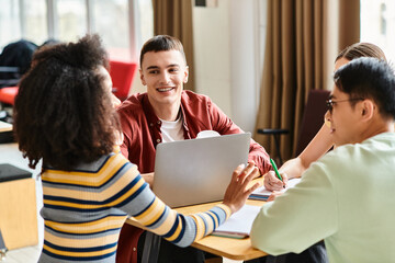 Wall Mural - A diverse group of students of Caucasian, Asian, and African American descent sharing a moment of happiness around a wooden table.