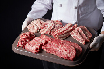 Canvas Print - Meat in various parts held by the chef