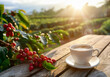 cup of hot coffee on table with red coffee beans and plantation on sunny day as background