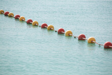 A Line Of Yellow Buoys Stretches Into The Aegean Sea