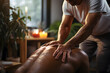 Professional masseur providing relaxing back massage in a serene spa environment. Wellness and therapeutic concept with candles for design and print. Close-up with warm lighting
