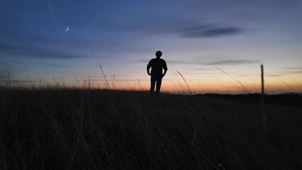 Wall Mural - man looking at night skies, observing celestial objects, moon, planets, meteors.