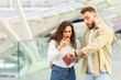 © Prostock-studio - Surprised Couple Checking Time in Urban Setting