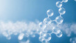 © Zag - realistic transparent molecules bonding 3d translucent atoms bonds with bokeh and light blue background blank space