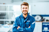 Fototapeta  - A young male technician's smile conveys friendliness and competence in a well-equipped technical lab