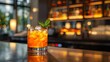 AI generated illustration of an orange drink with mint garnish on bar counter