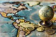 Close-up of coins and a small globe on a detailed world map, symbolizing international finance