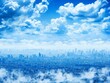 City skyline with skyscrapers rising above a dreamy blanket of clouds against a clear blue sky