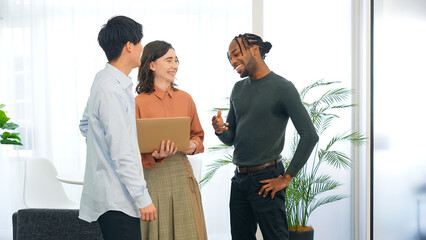 Poster - Multinational people talking while looking at laptop PC in the lobby. International business.