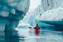 A Person In A Red Kayak Amidst Towering, Icy Blue Glaciers, Capturing The Serene Yet Adventurous Spirit Of Arctic Exploration