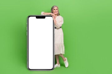 Sticker - Full length photo of shiny dreamy lady wear beige dress typing modern gadget looking empty space isolated green color background