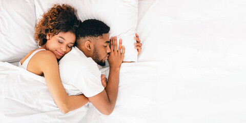 Wall Mural - Loving couple sleeping in bed and hugging