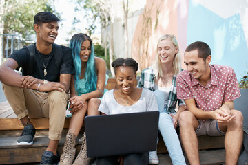 Smile, students and outdoors with laptop on stairs for education, discussion and online research for project. Diversity, friends and laughing with technology for funny email, teamwork and comedy post