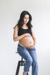 Pregnant woman sitting on a stool