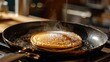 frying pan on the pancake on a stove 