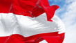 Close-up of the national flag of Austria waving on a clear day.