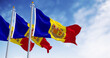 Flags of the Principality of Andorra waving in the wind on a clear day