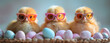 Three cute ducklings wearing colorful sunglasses sitting beside pastel-colored Easter eggs on a soft, blurred background.