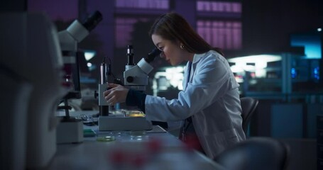 Aufkleber - Genetic Research Scientist Using Microscope in an Applied Science Laboratory in the Evening. Portrait of a Beautiful Asian Lab Engineer in White Coat Developing New Medical Products