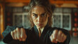 Determined woman in martial arts pose ready to combat