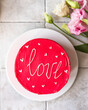 Bento cake with inscription Love and hearts. Small Korean style cake for one person. A cute dessert gift for any occasion for a loved one.