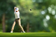 Golfer driver back swing before hitting golf ball down the fairway.