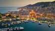 Aerial evening shot of Ajaccio old town, Corsica island. Flying over harbor, old houses and city lights in Ajaccio - capital of Corsica, France
