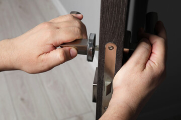 Sticker - Handyman repairing door handle indoors, closeup view