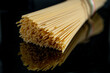 Italian pasta spaghetti noodles on reflecting black background surface raw ingredient for recipe 