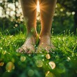 Fresh, dewy feel of bare feet standing in morning grass, with sunlight creating a soft, warm glow