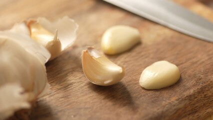 Garlic cloves on a cutting board. Close-up, shallow dof.