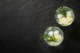 Fototapeta  - Gin tonic, traditional cocktail on black background. Top view with space for design.