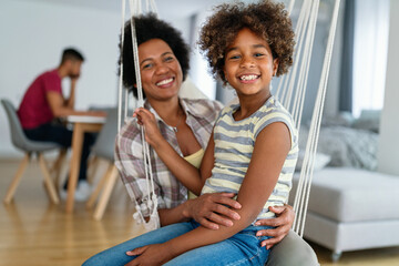 Wall Mural - Family concept. Happy african american mother and daughter spendig fun time together at home