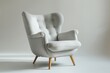 Scandinavian design armchair, light grey fabric, white background, natural daylight,  3/4 camera angle.