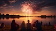 couple in love sitting by a lake on a beautiful sunset with real grand fireworks. celebration concept with friends