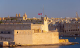 Fototapeta Boho - Old forts on the stone city wall above Valletta Bay.