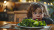 Photo capturing the moment of reluctance as a child stares at a plate of green leafy vegetables their expression a mix of dismay and stubborn refusal