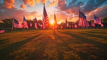 American Flags On A Sunny Field During Sunrise. Patriotic Landscape. National Holiday And Remembrance Concept