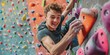 © igorfrost - young athletic man wearing sportswear climbing wall indoors, smiling portrait