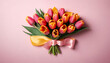 Top view photo of stylish with ribbon bow and bouquet of tulips