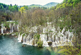Fototapeta Krajobraz - Amazing picture with some of picturesque waterfalls in the green spring forest of Plitvice national park in Croatia. Plitvice lakes closer view..