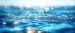 A blurred background of blue water with light ripples and waves, creating an abstract bokeh effect that adds depth to the composition. The focus is on the sparkling surface of the sea or ocean.
