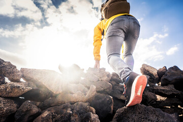 Canvas Print - Hiker climbing mountains - Close up of successful climber standing on the top the of cliff - Focus on shoes