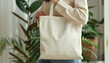 ©  ArtificialMango - Woman holding blank eco tote bag