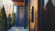 Contemporary home entrance featuring a modern door with a smart lock system at sunset