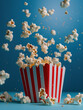 Dynamic popcorn explosion from classic red and white striped box against a vibrant blue background